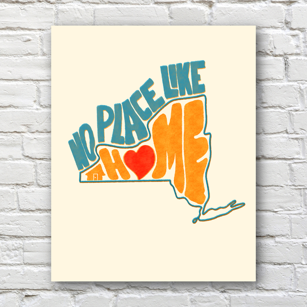 A vertical art print featuring the phrase 'NO PLACE LIKE HOME' in teal and orange lettering with a red heart, displayed against a white brick wall background.