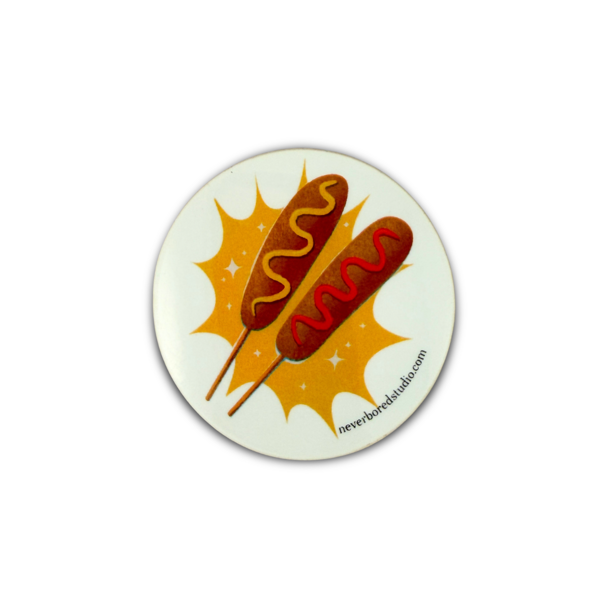 A die-cut sticker featuring an illustration of two hot dogs on sticks with mustard and ketchup against a yellow starburst background on an off-white base.